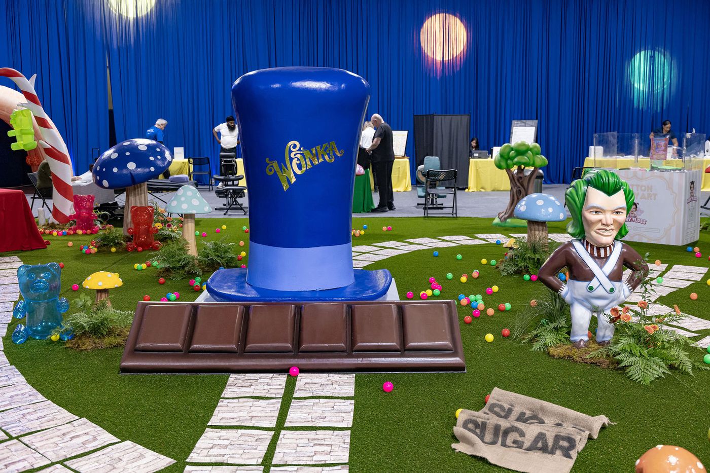 A wide view of an immersive confectionery world built inside an event hall