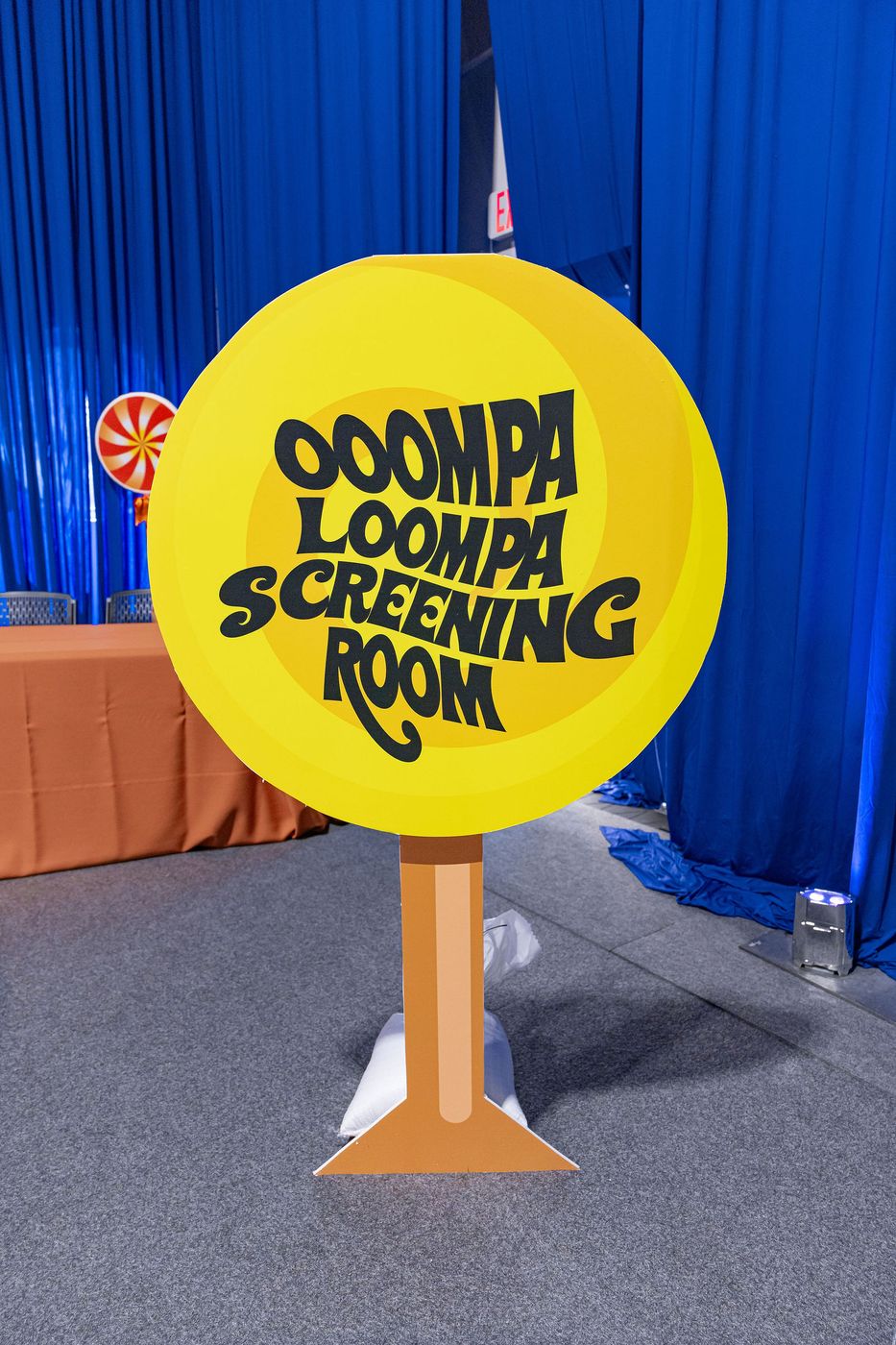 A hand painted screening room sign at an immersive confectionery event