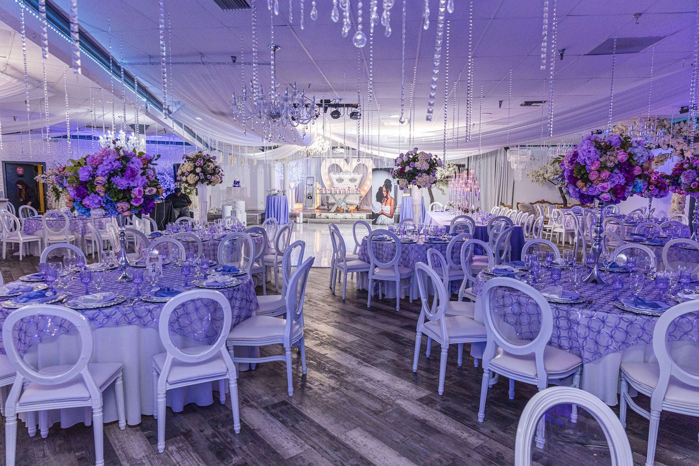 Lavender banquet tables and crystal chandeliers set for a sweet sixteen
