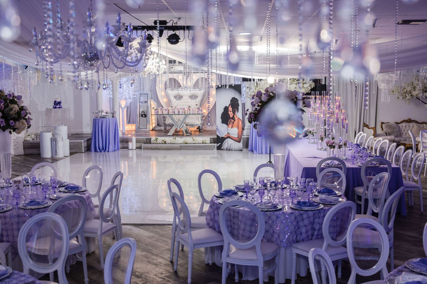 A marquee heart and mirrored stage at the head of a sweet sixteen ballroom