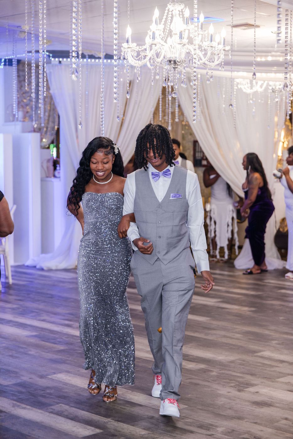 The guest of honour escorted into her sweet sixteen through a draped entrance