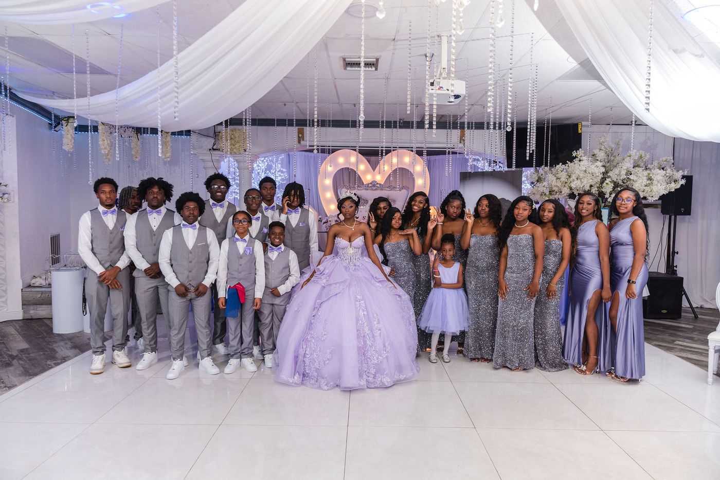 The full court photographed together at a sweet sixteen celebration