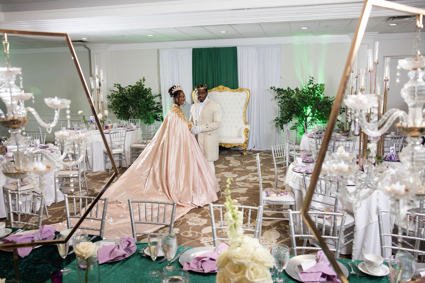A Regency themed ball laid with candelabra, potted trees and emerald linen