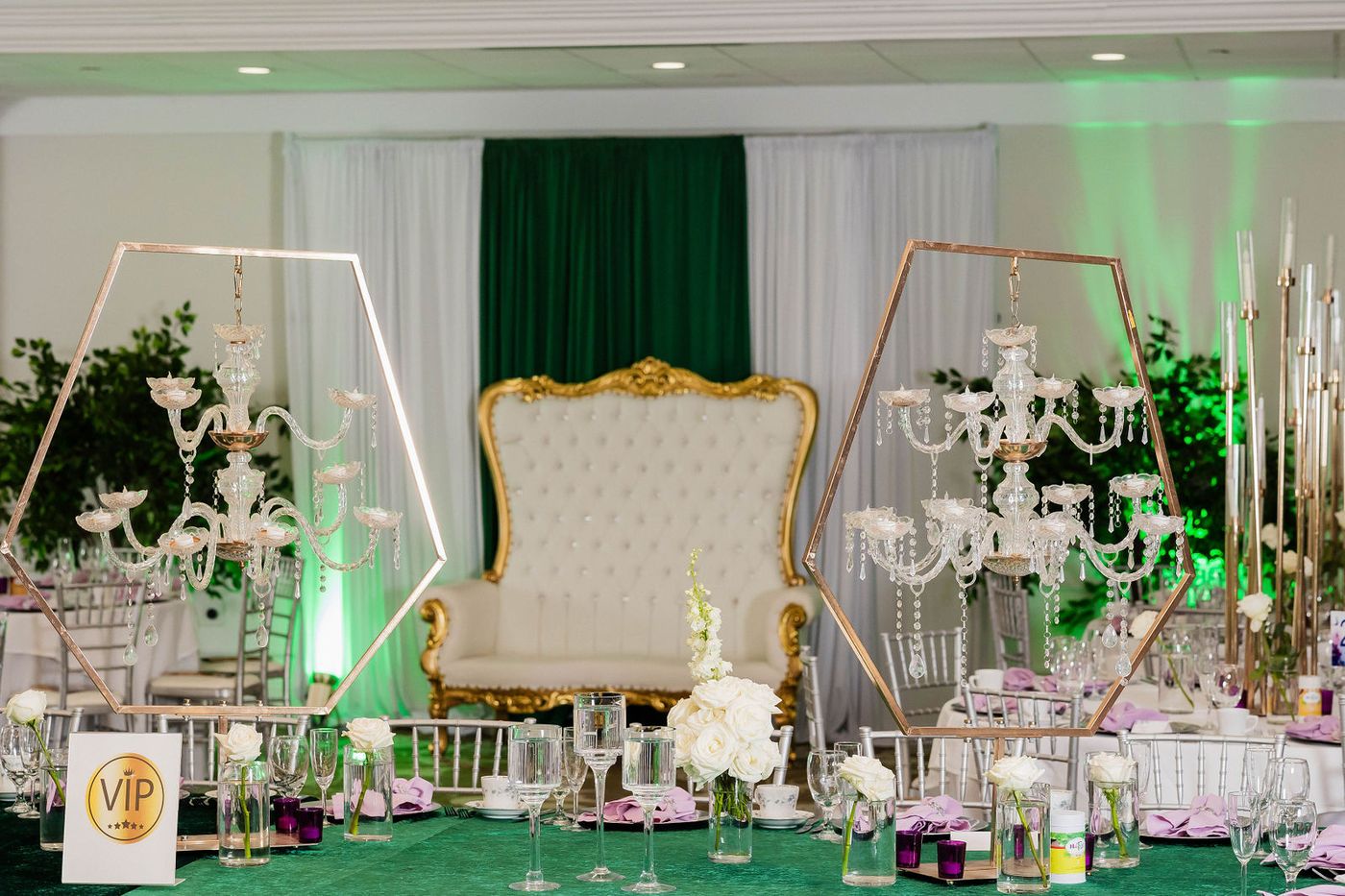 A gilded throne set against emerald drapery at a costume ball