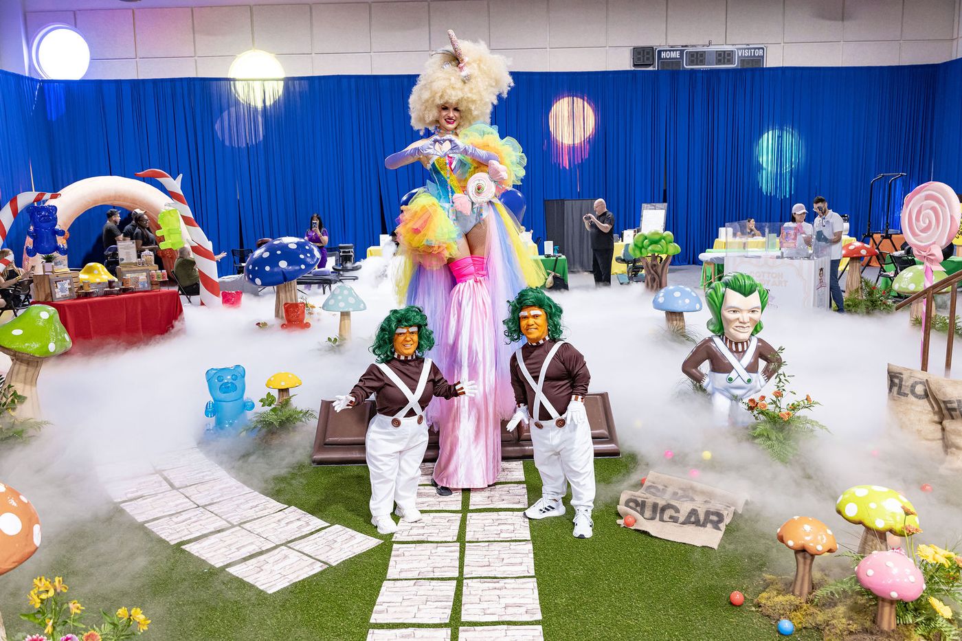 An immersive confectionery themed event build filling with low fog as the characters take the floor