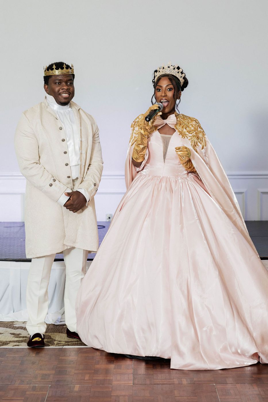 A couple in ivory and gold court dress at a Regency themed ball
