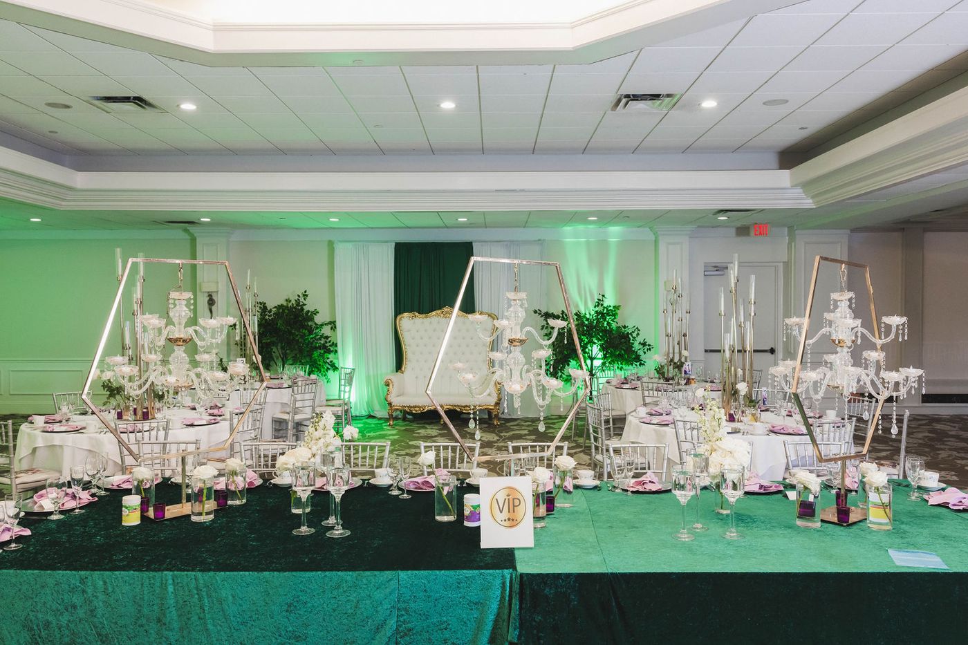 The ballroom of a Regency themed ball, dressed with trees and candelabra