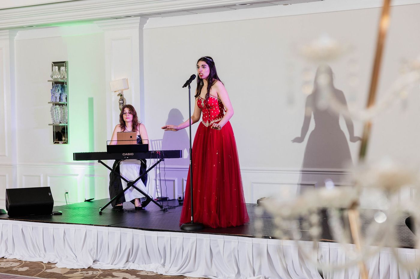 A singer performing on stage at a themed ball in South Florida