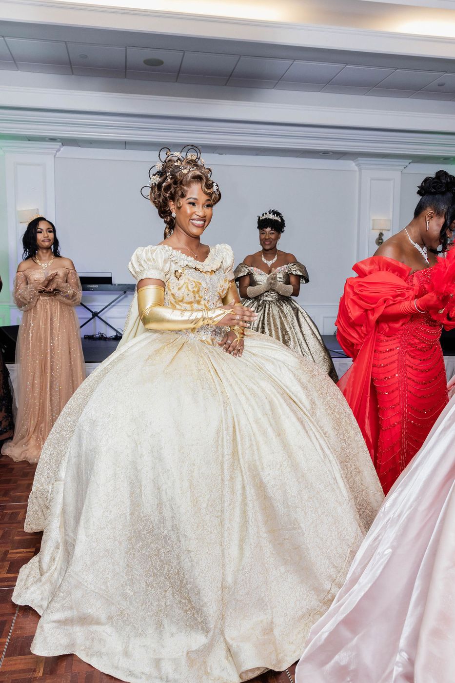 A guest in a gold court gown on the dance floor