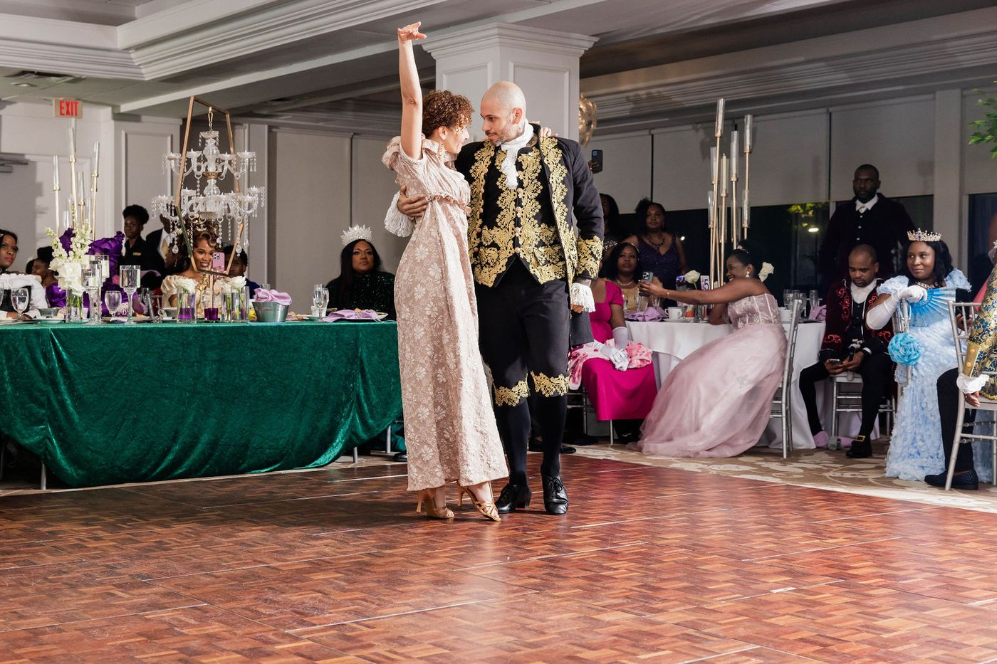 A couple dancing in full court dress at a themed ball