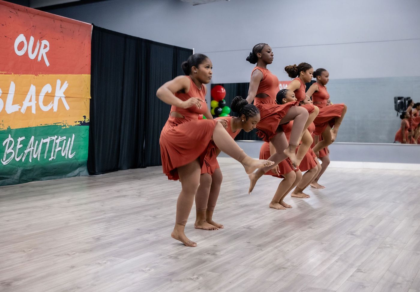A dance company mid-routine at a performing arts showcase