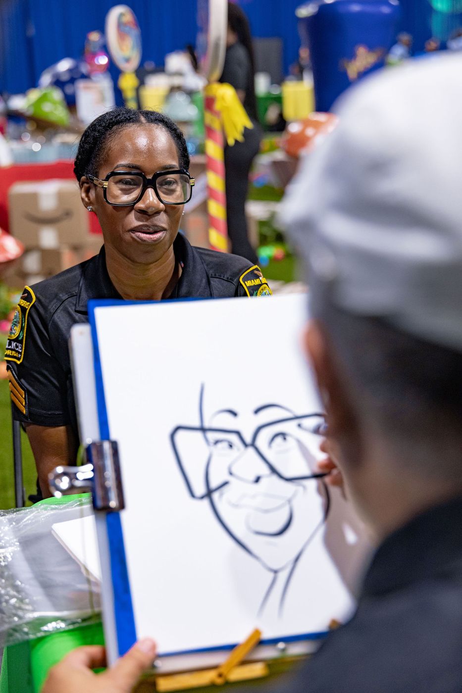 A caricature artist drawing a guest at a community event activation
