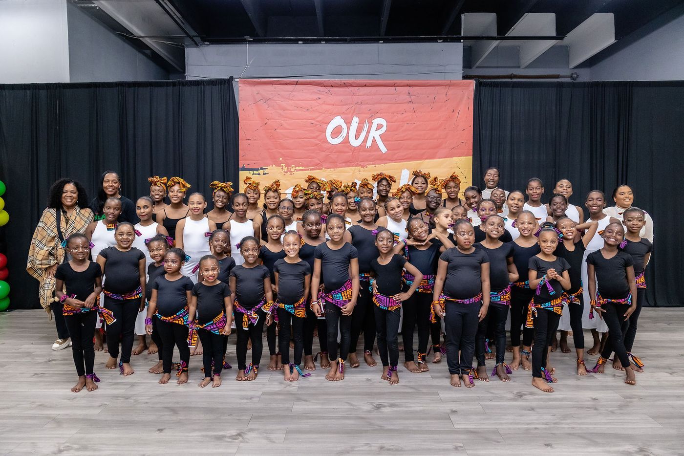 The entire cast of a performing arts studio photographed together after the showcase