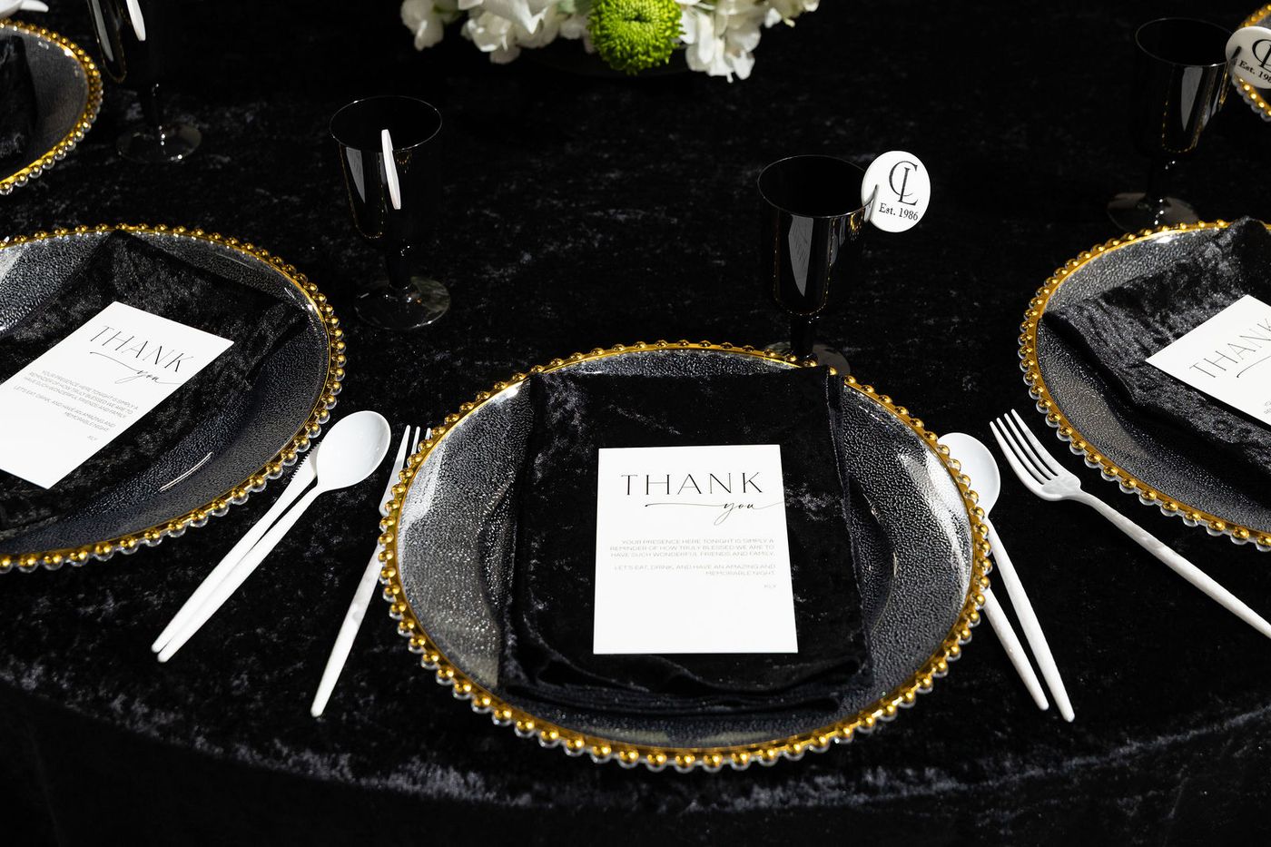A black and white seating chart wall with a champagne display