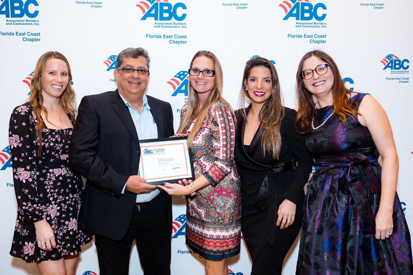 A member receiving a certificate at an industry association end-of-year event