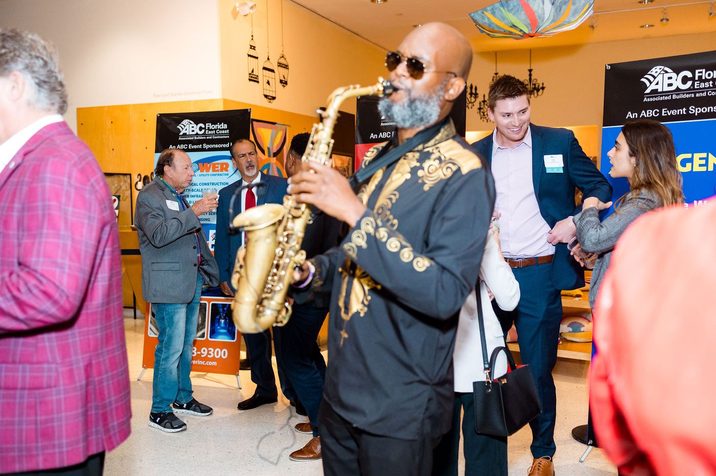 A saxophonist working the room during a corporate reception