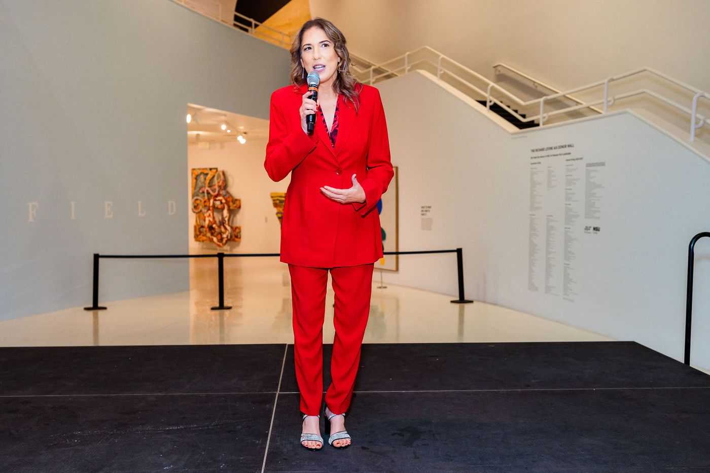 The host addressing the room from the stage at a corporate end-of-year event