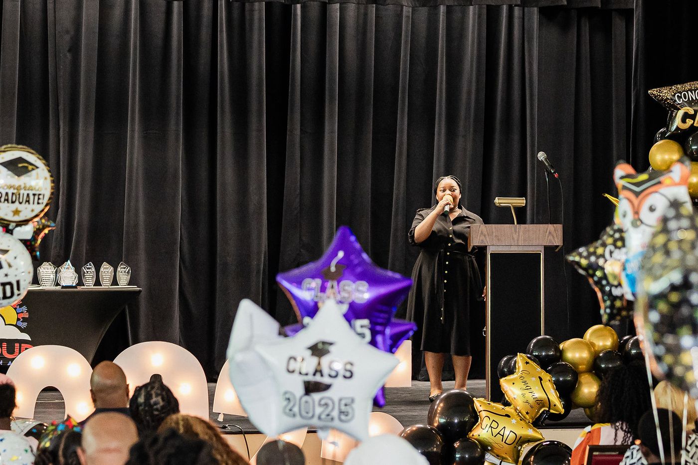 A speaker at the podium during a Class of 2025 graduation ceremony