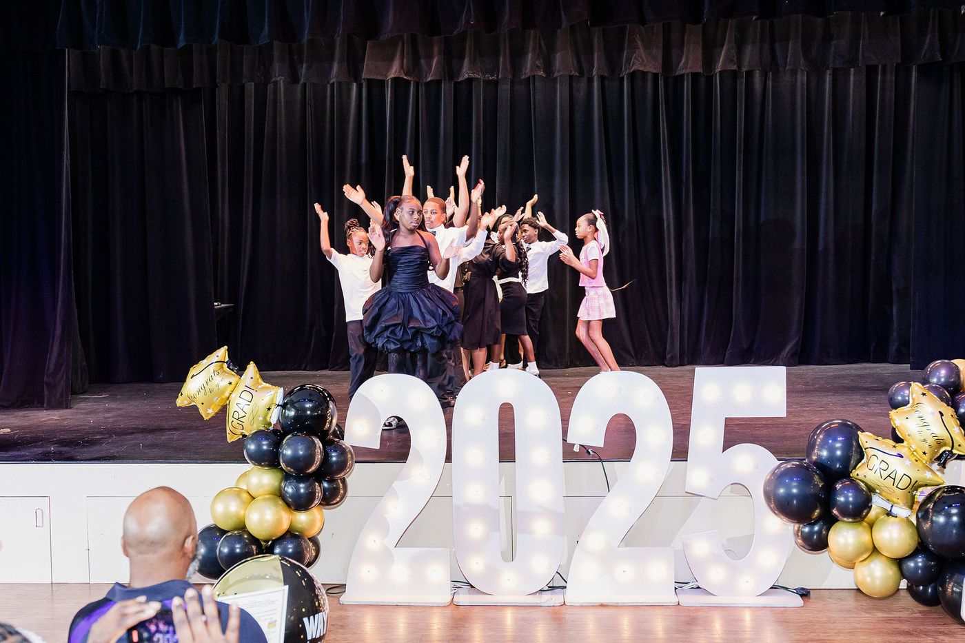 Children performing together at a Class of 2025 graduation