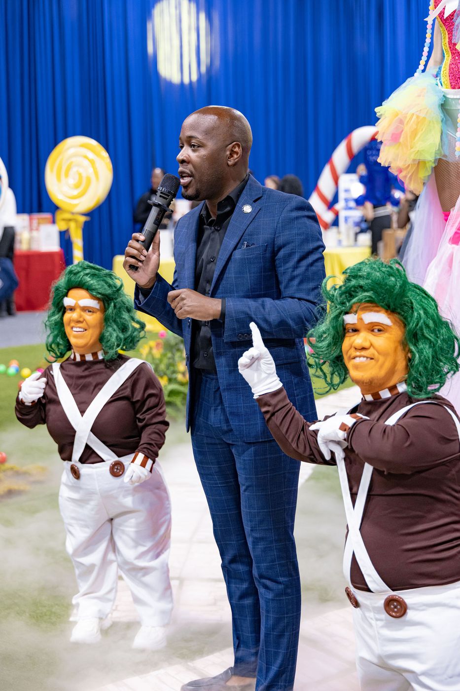 The host working the floor with a microphone at a themed family event