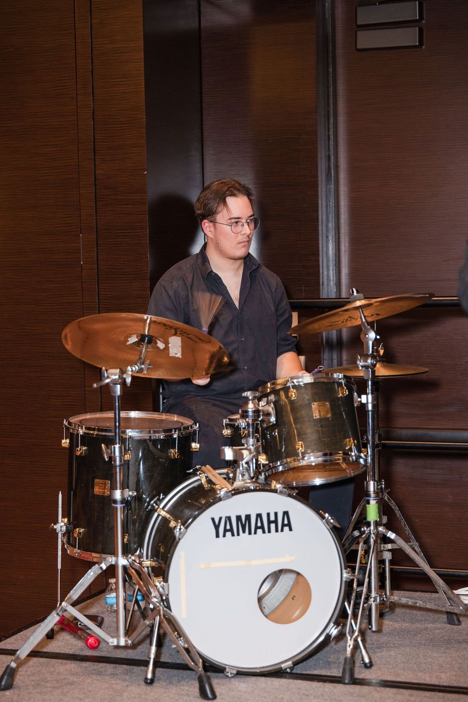 A live band playing at a corporate holiday party in a hotel ballroom