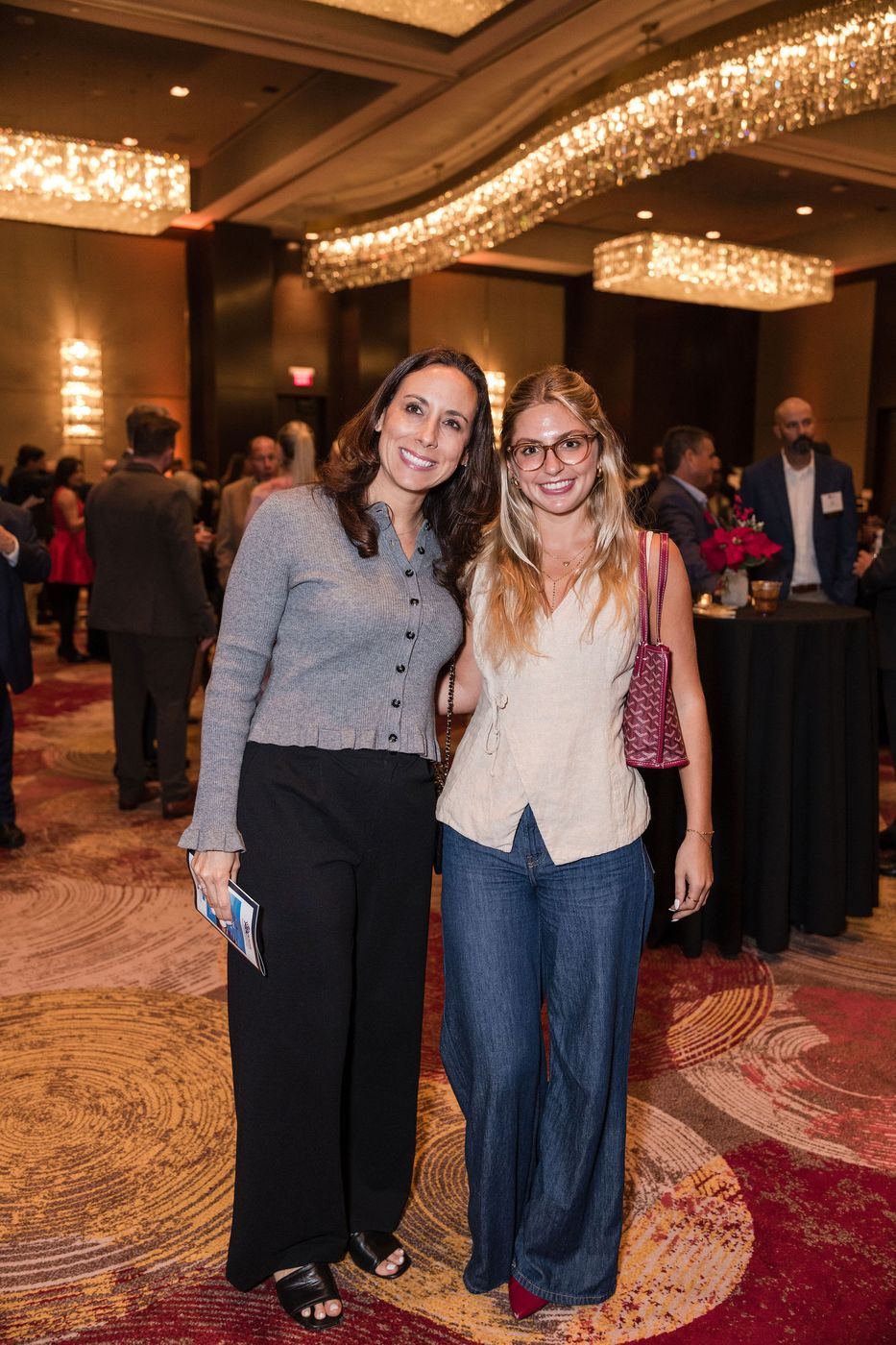 Two guests at an industry holiday celebration in a South Florida hotel ballroom