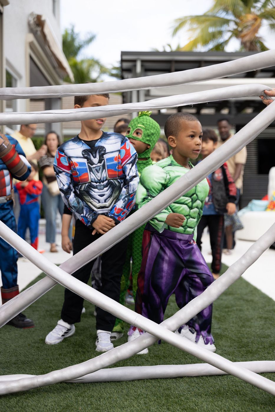 Children climbing a sculptural play frame at a themed birthday party