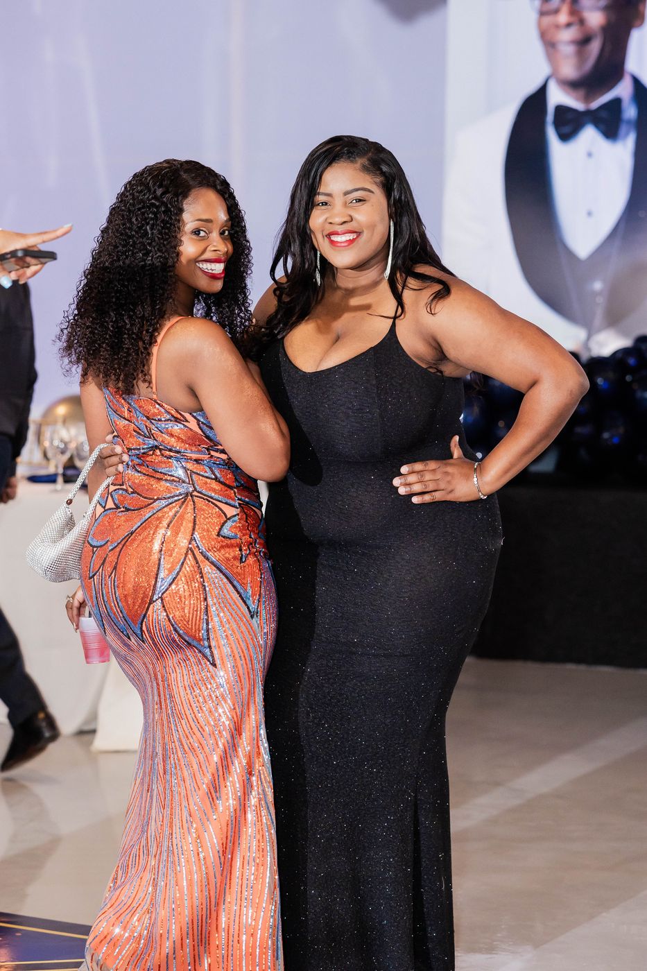 Two guests photographed together at a 70th birthday celebration