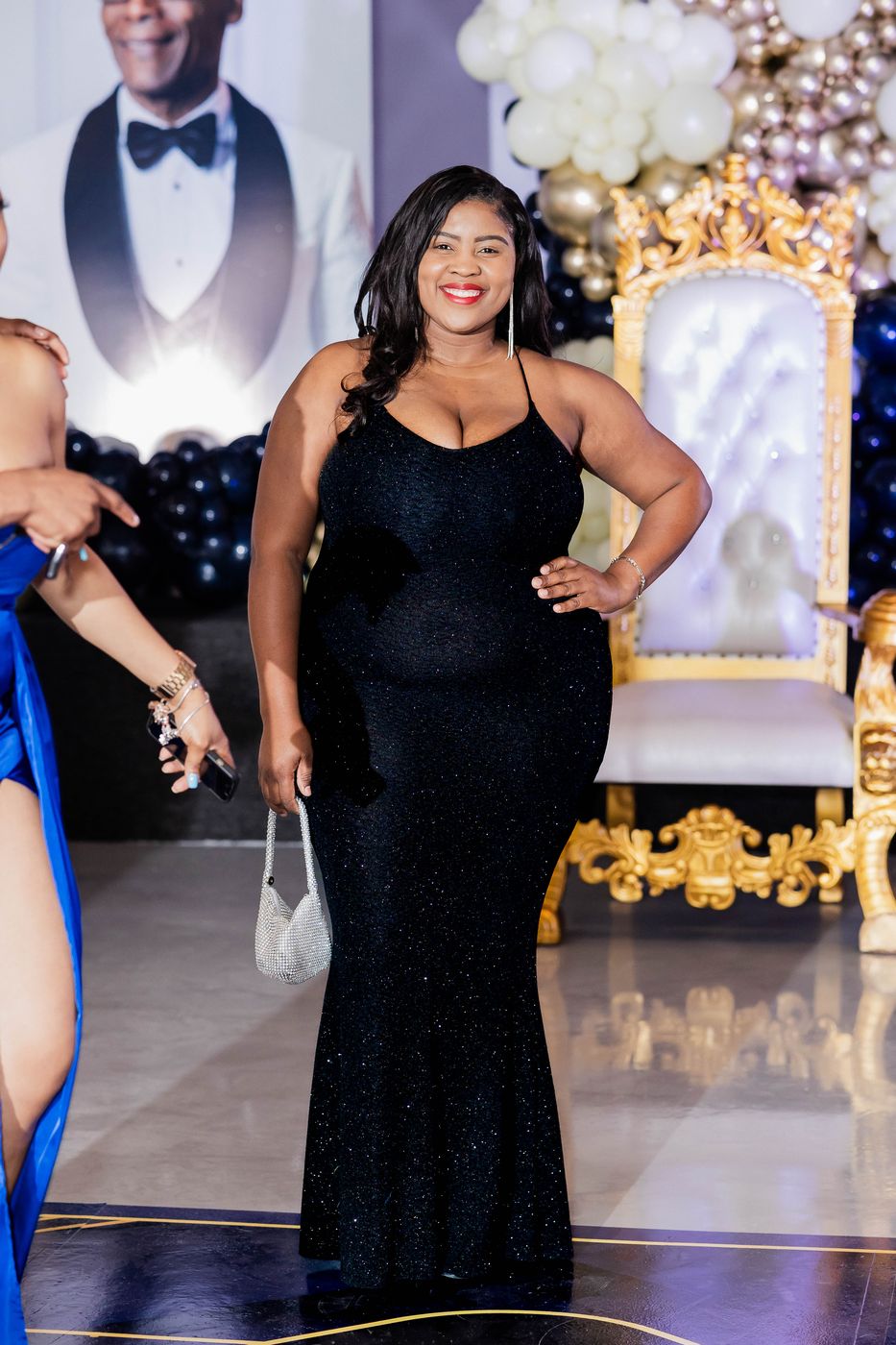 A guest in a floor-length black gown at the portrait station
