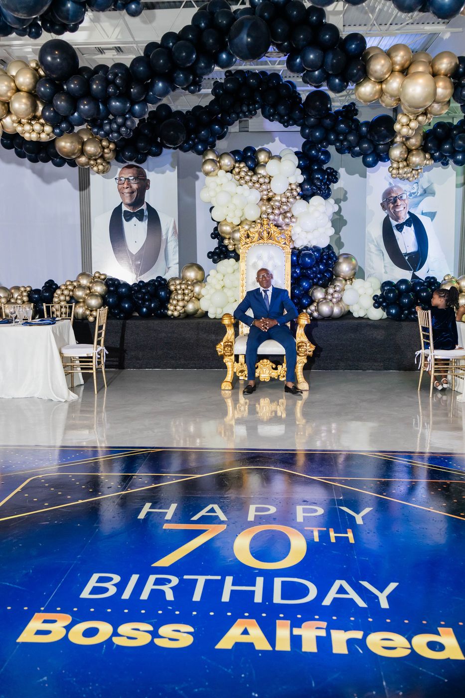 A custom monogrammed dance floor reading Happy 70th Birthday
