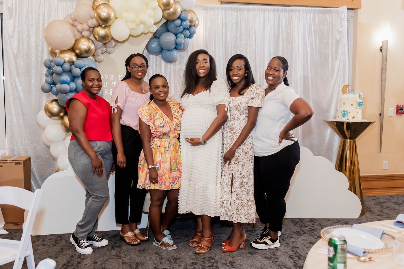 Guests gathered at the baby shower backdrop