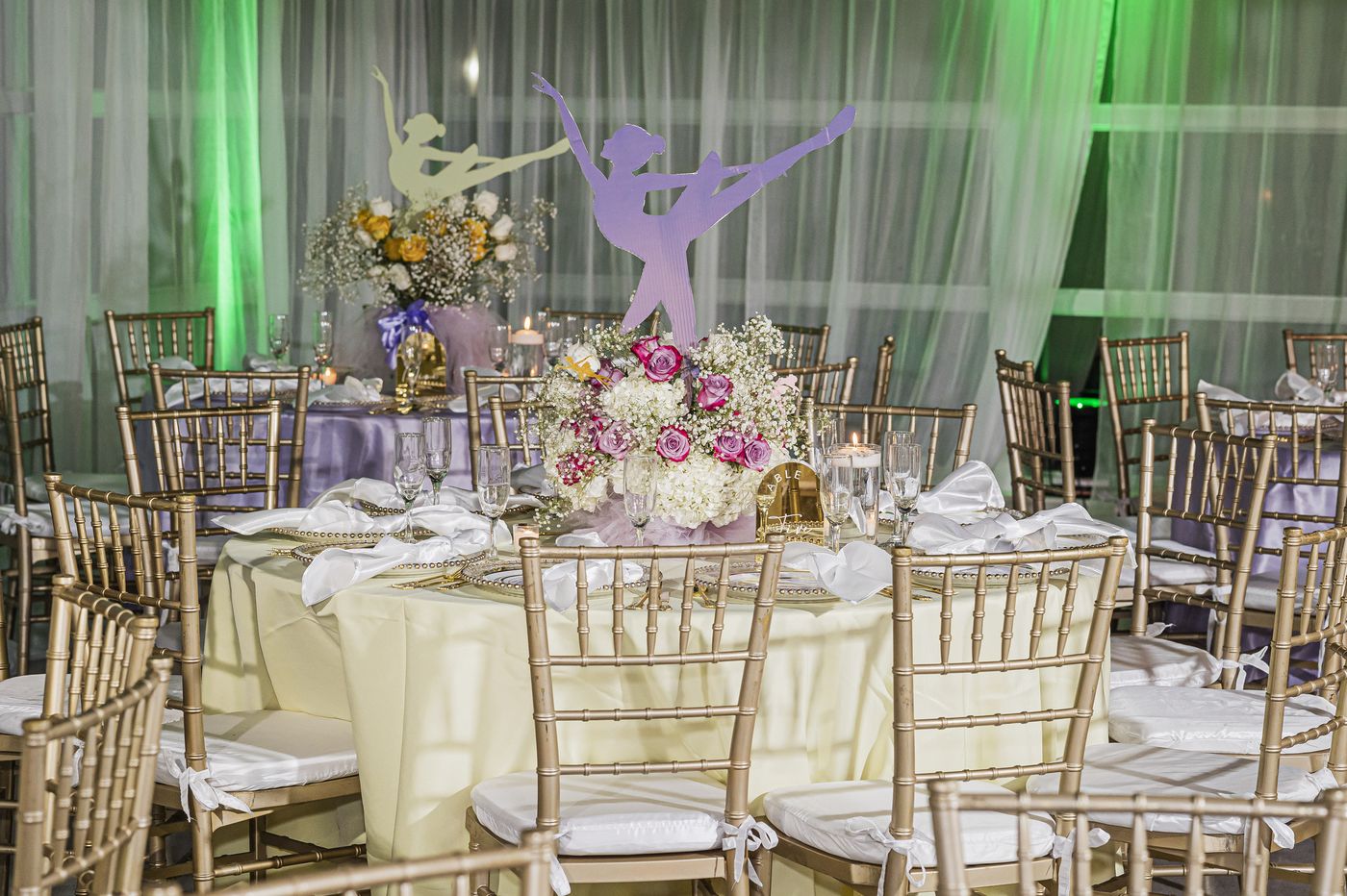 A ballerina silhouette and floral centrepiece at a baby shower
