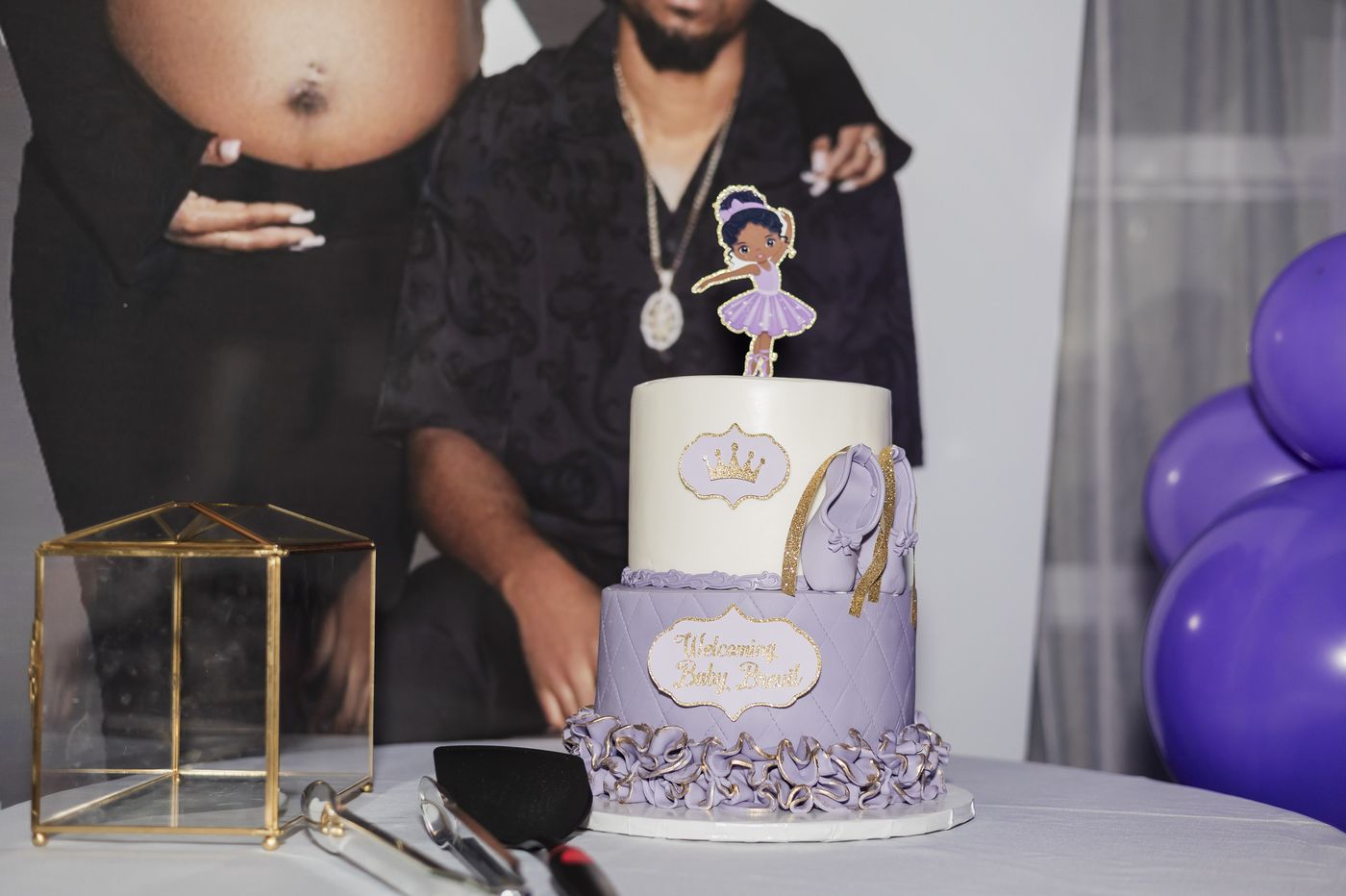 A lilac ballerina cake at a baby shower