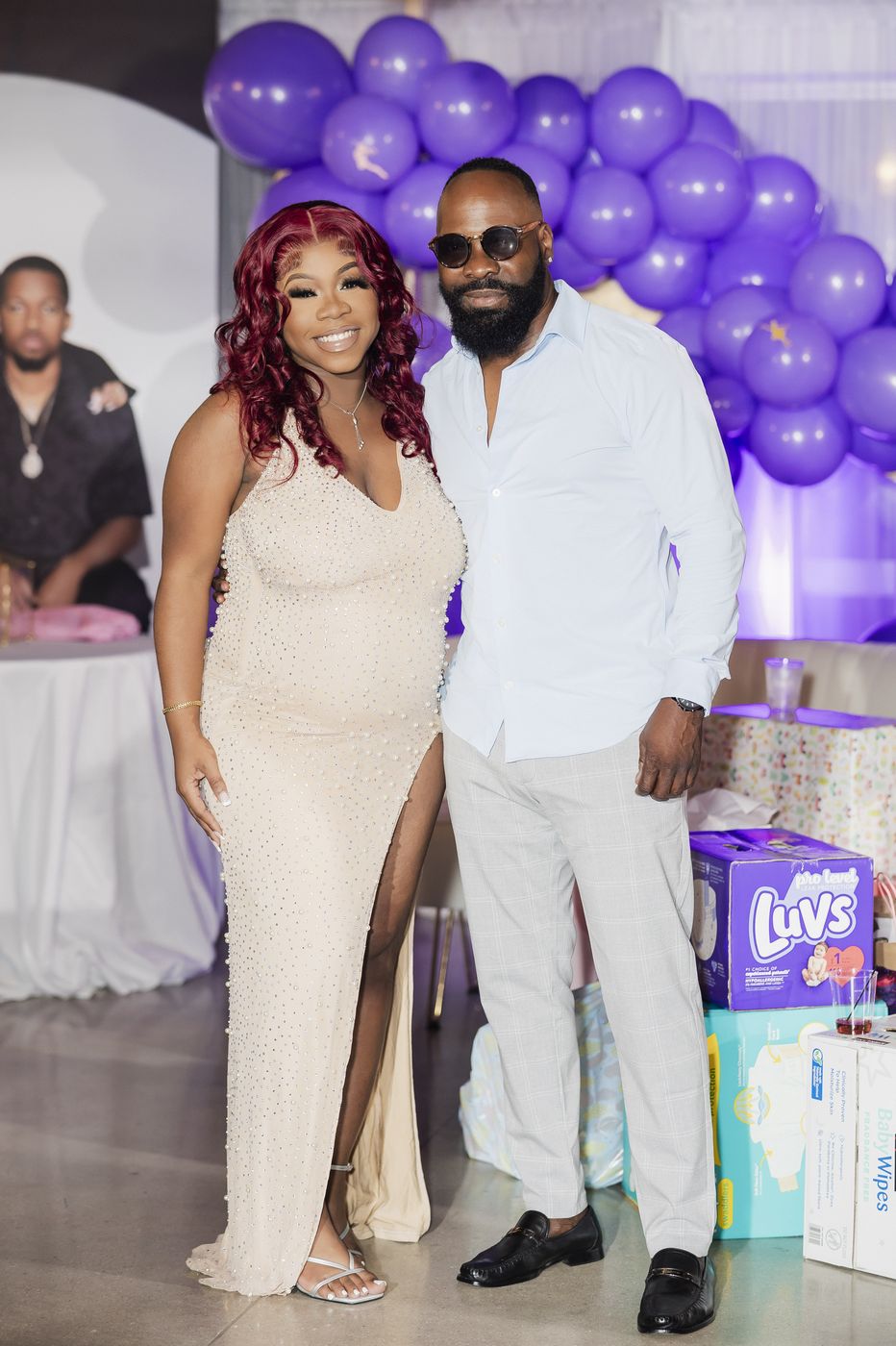 The parents-to-be at the purple balloon arch