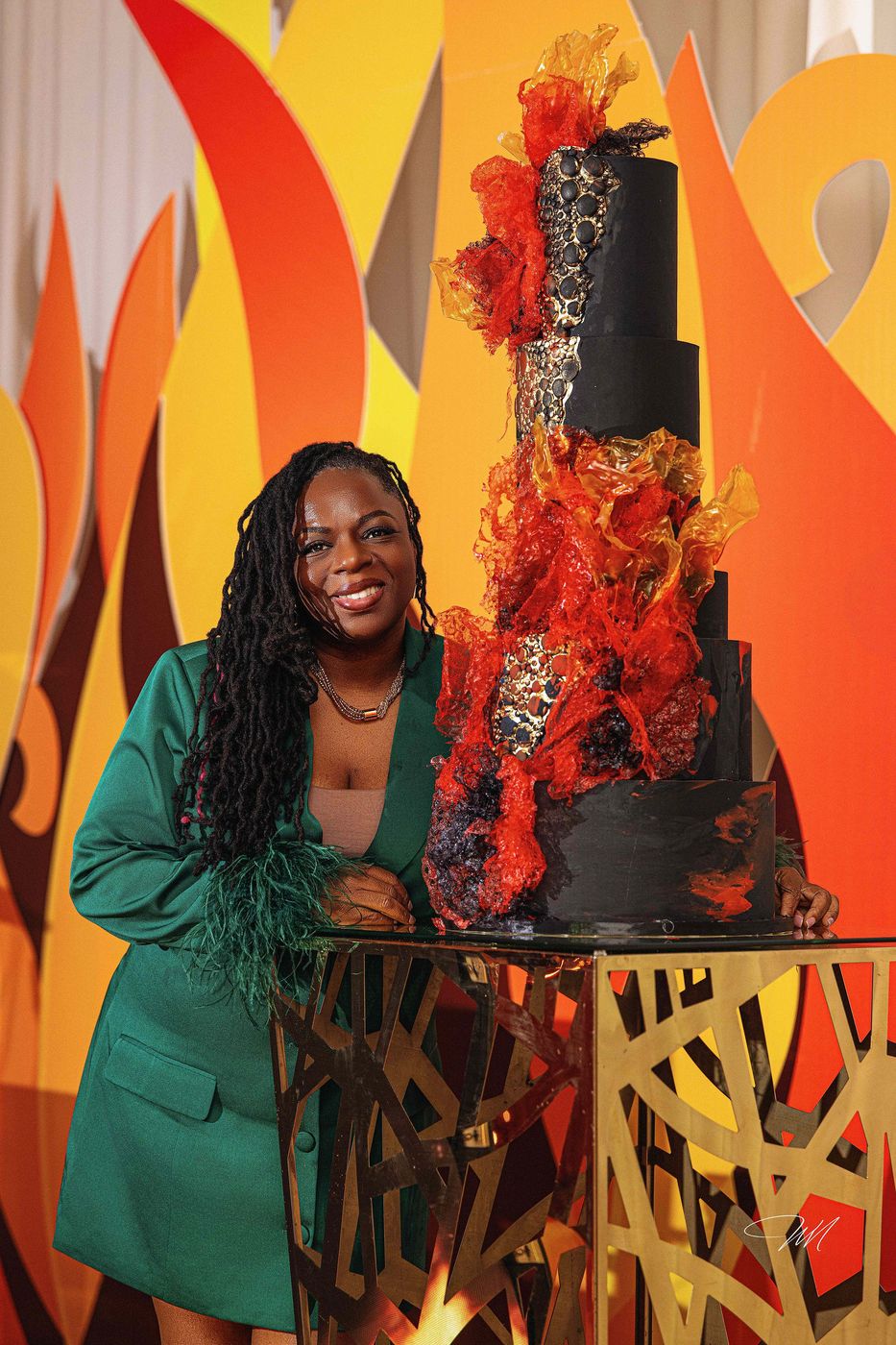 The guest of honour beside her flame themed birthday cake