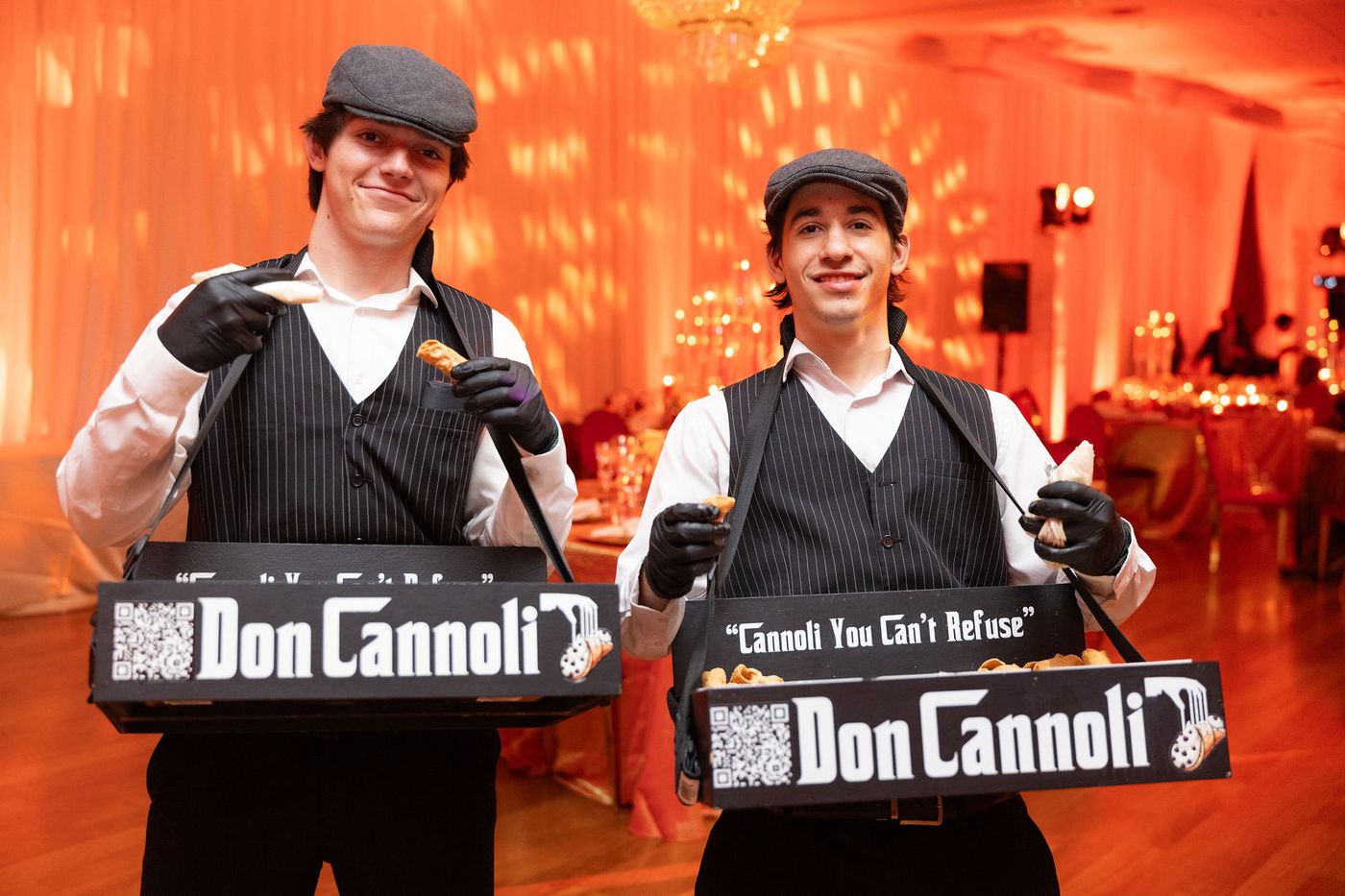 Two cannoli vendors working the floor of a milestone celebration