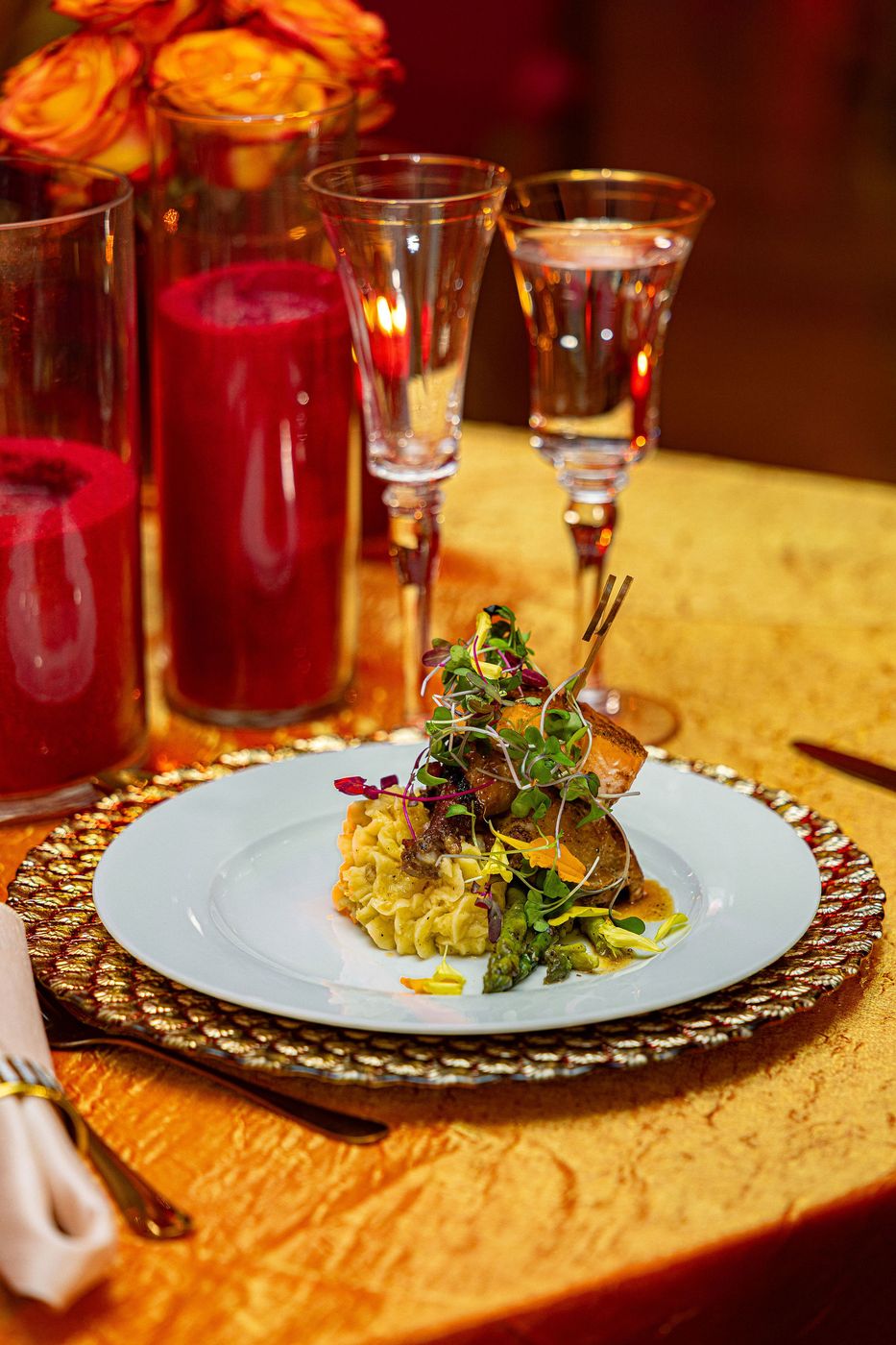 A plated main course photographed on the table at a candlelit gala