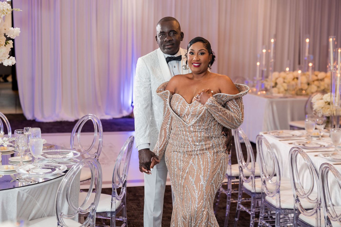 A couple photographed together in the ballroom at their 25th anniversary