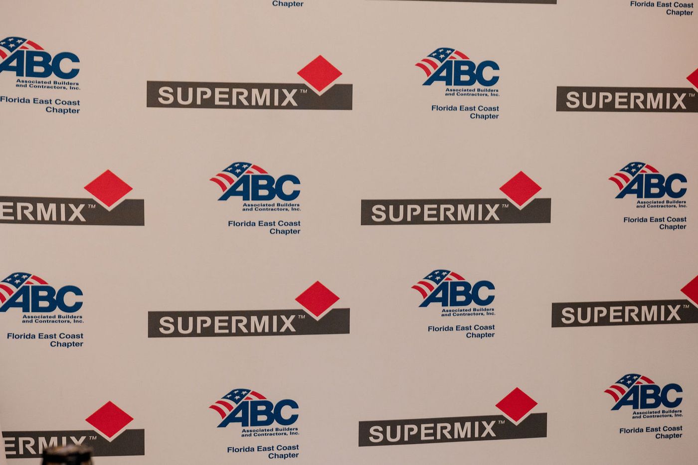 The sponsor step and repeat backdrop at an awards banquet reception