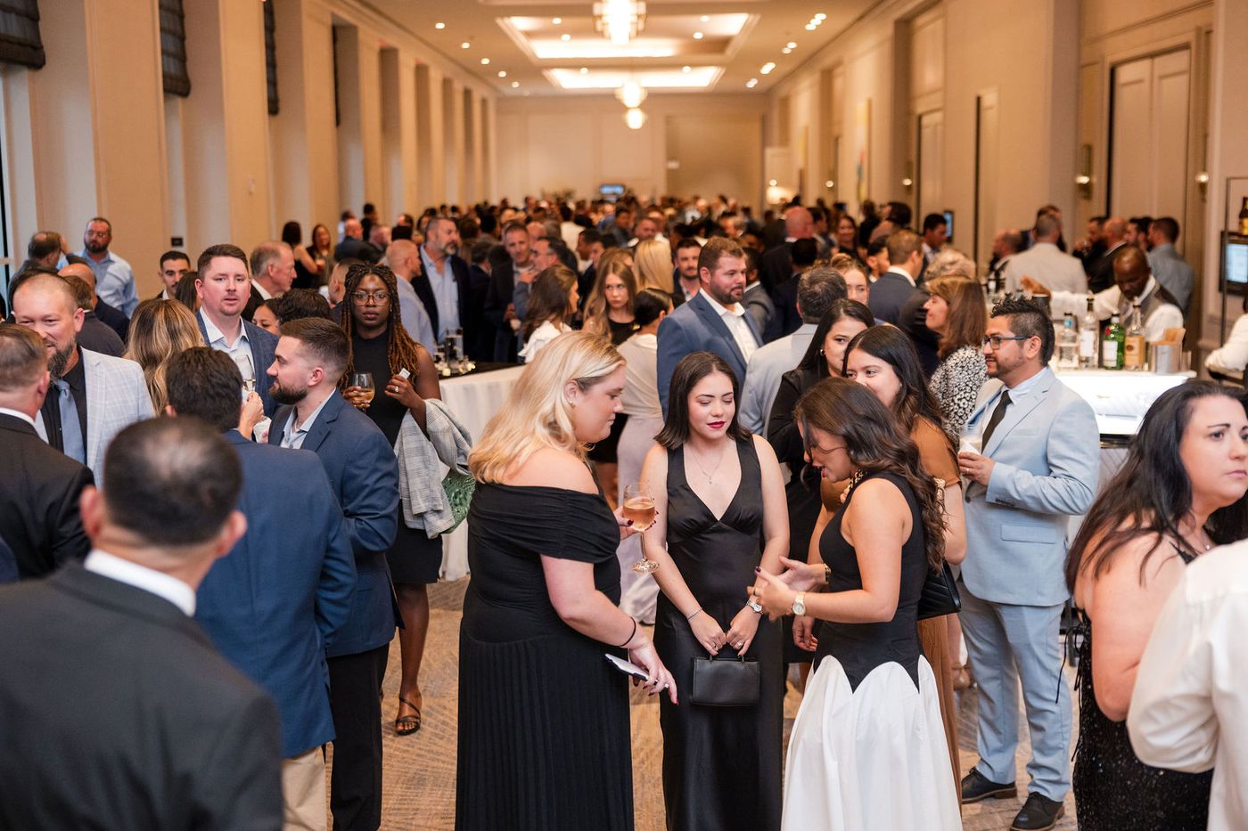 Guests in evening dress during the cocktail reception of a South Florida gala
