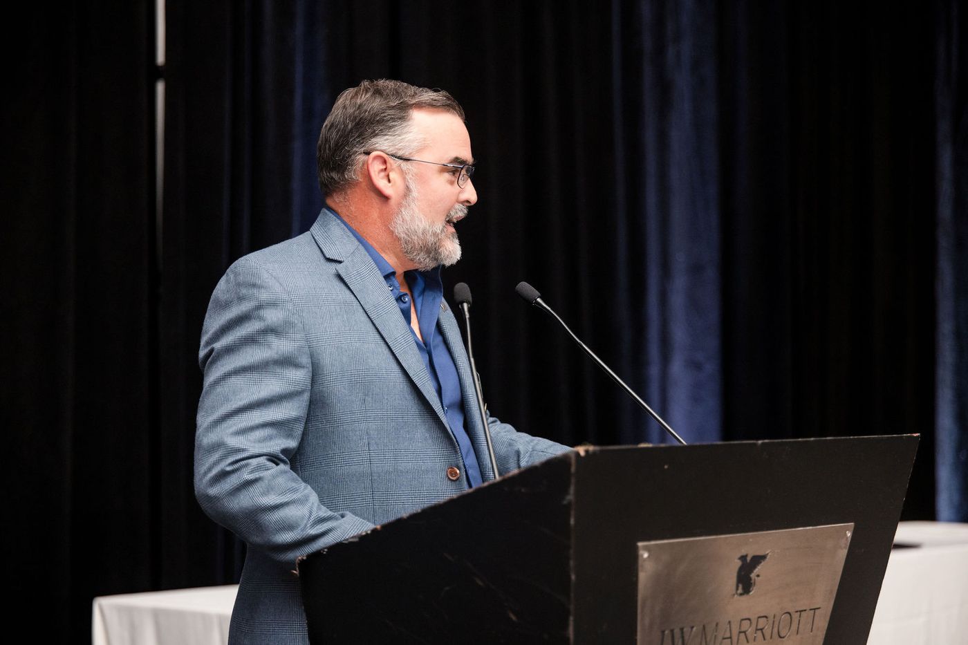 A speaker at the podium during the programme of a South Florida awards banquet