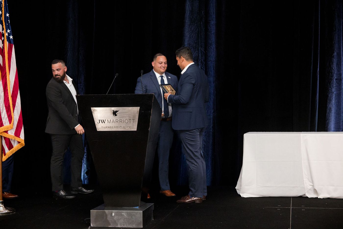 An award presented on stage in front of a full ballroom