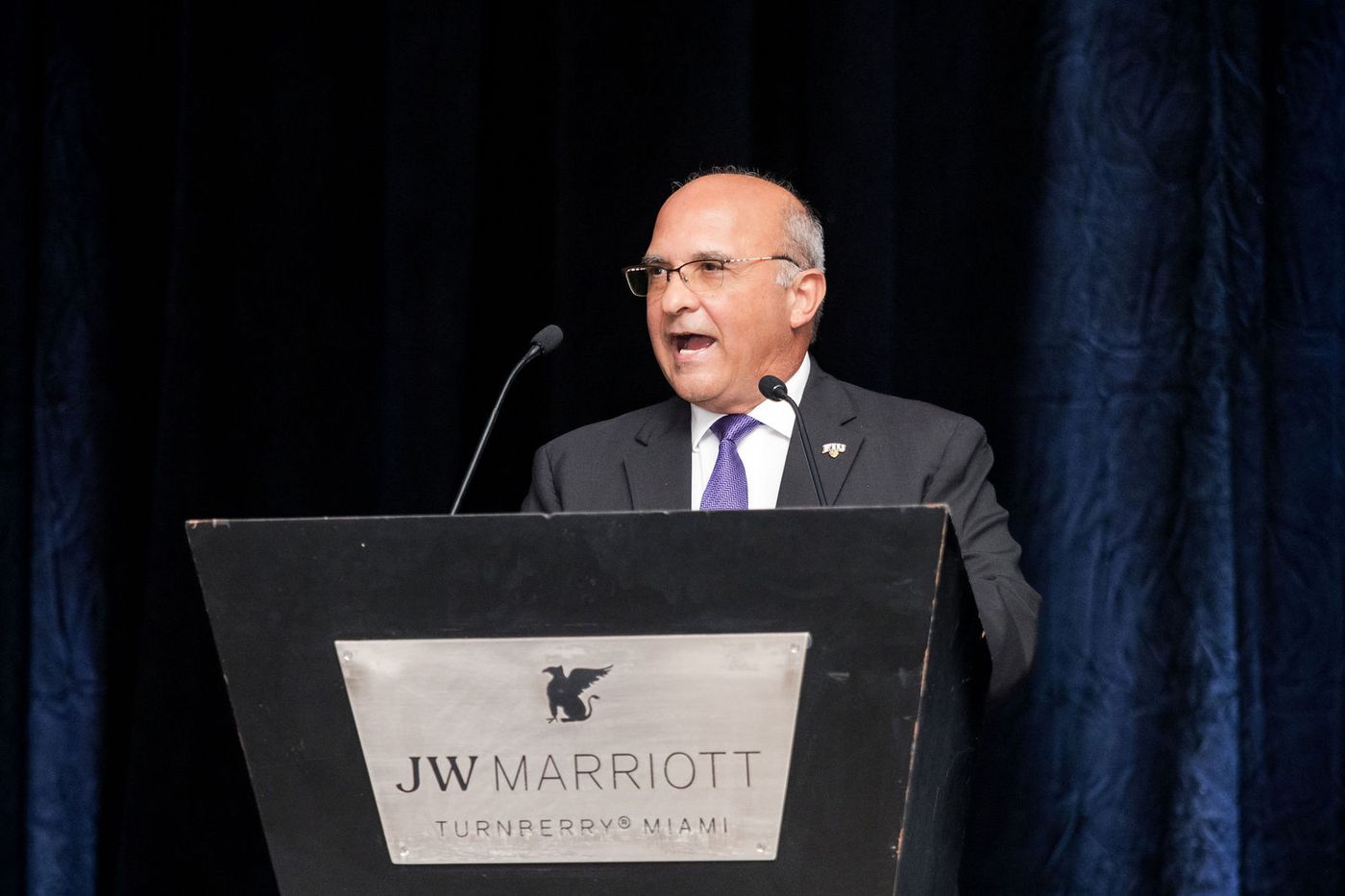 A association president speaking from the podium at an awards gala